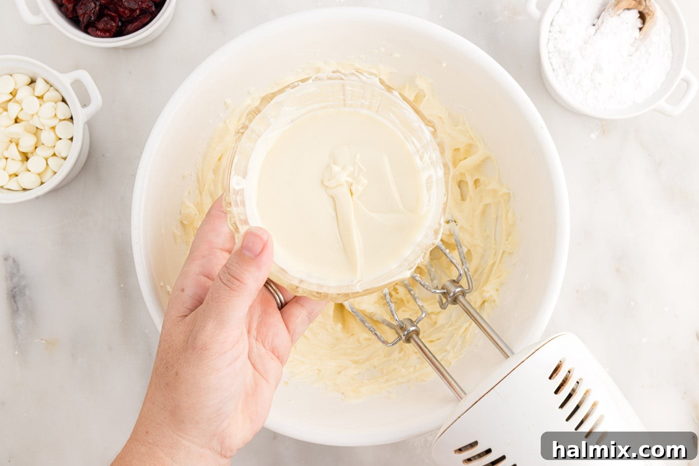 Tangy Cranberry Dream Bars 12 adding melted white chocolate to cream cheese frosting