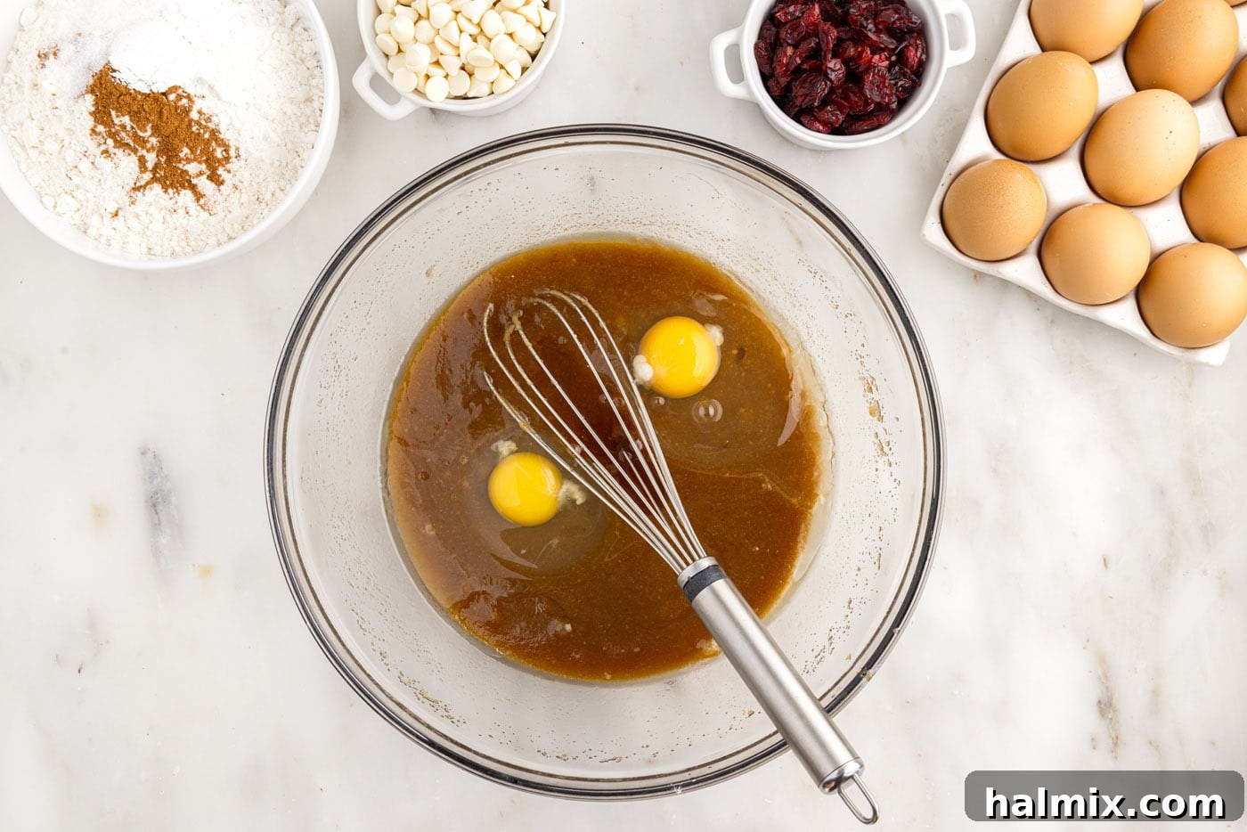 Tangy Cranberry Dream Bars 6 adding eggs to butter and sugar mixture in a bowl