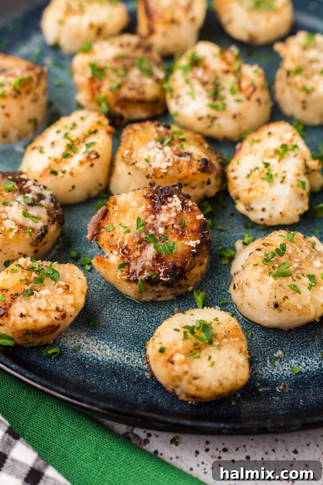 Close up photo of Grilled Scallops with a golden-brown crust and melted Parmesan