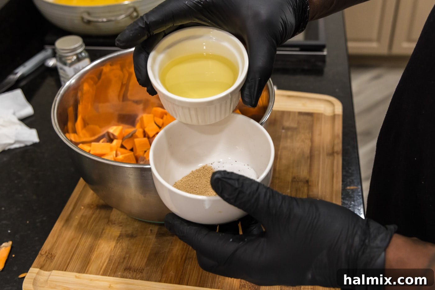 adding olive oil to seasonings in a bowl