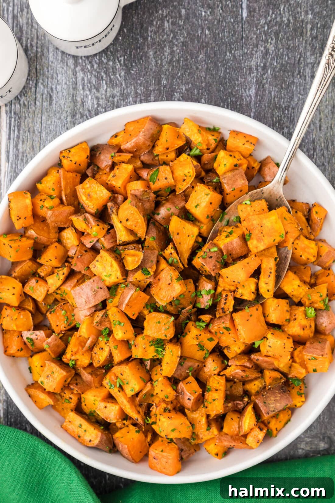Caramelized Sweet Potatoes 10 Bowl of Roasted Sweet Potatoes with a spoon in it