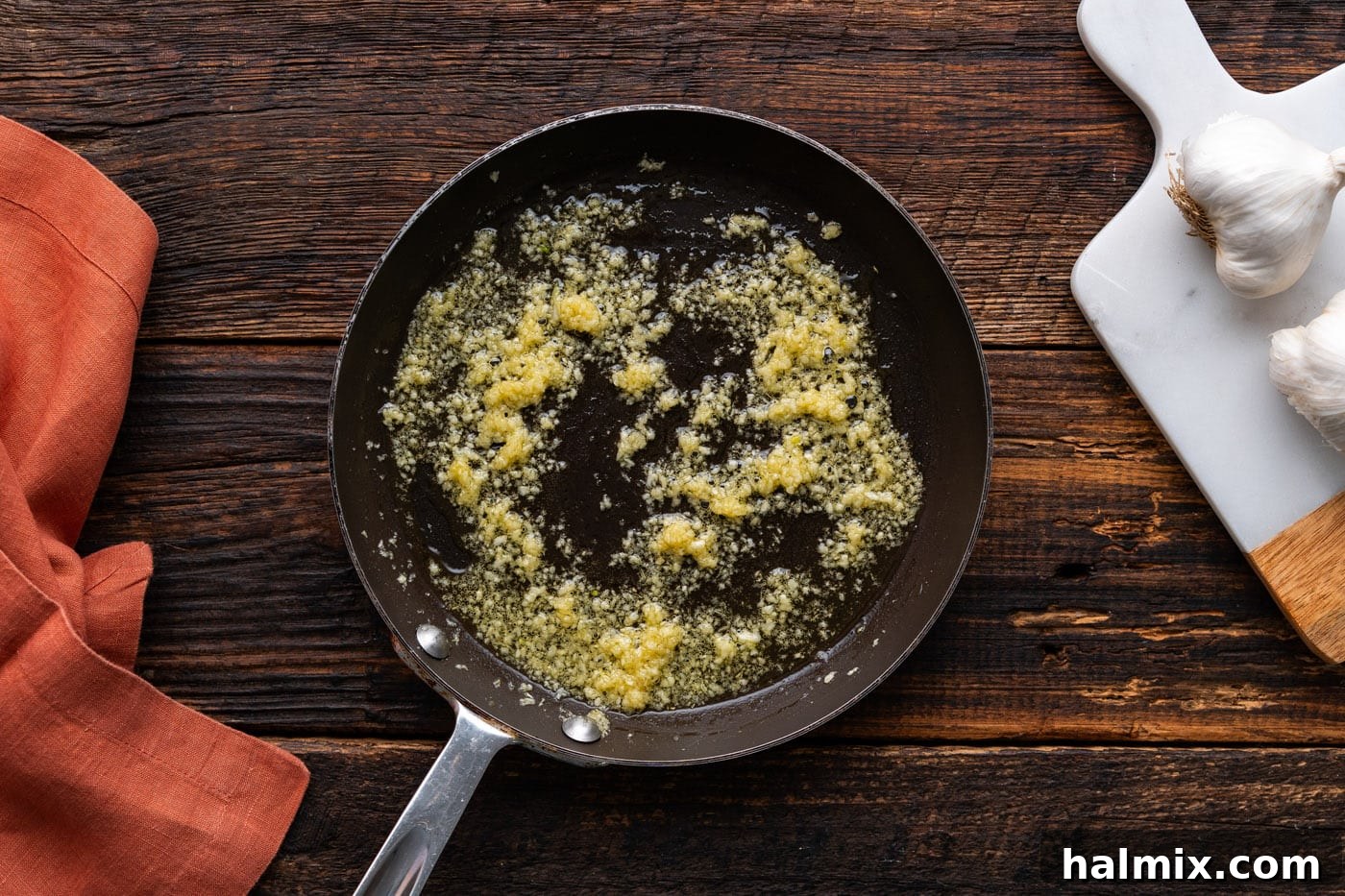 Olive oil and minced garlic simmering gently in a skillet