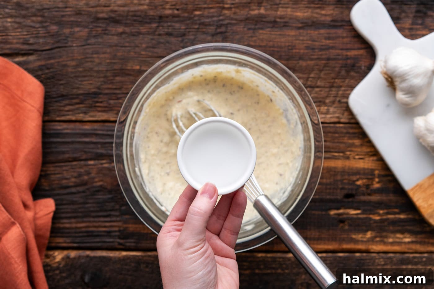 Adding water to adjust the consistency of homemade wing sauce
