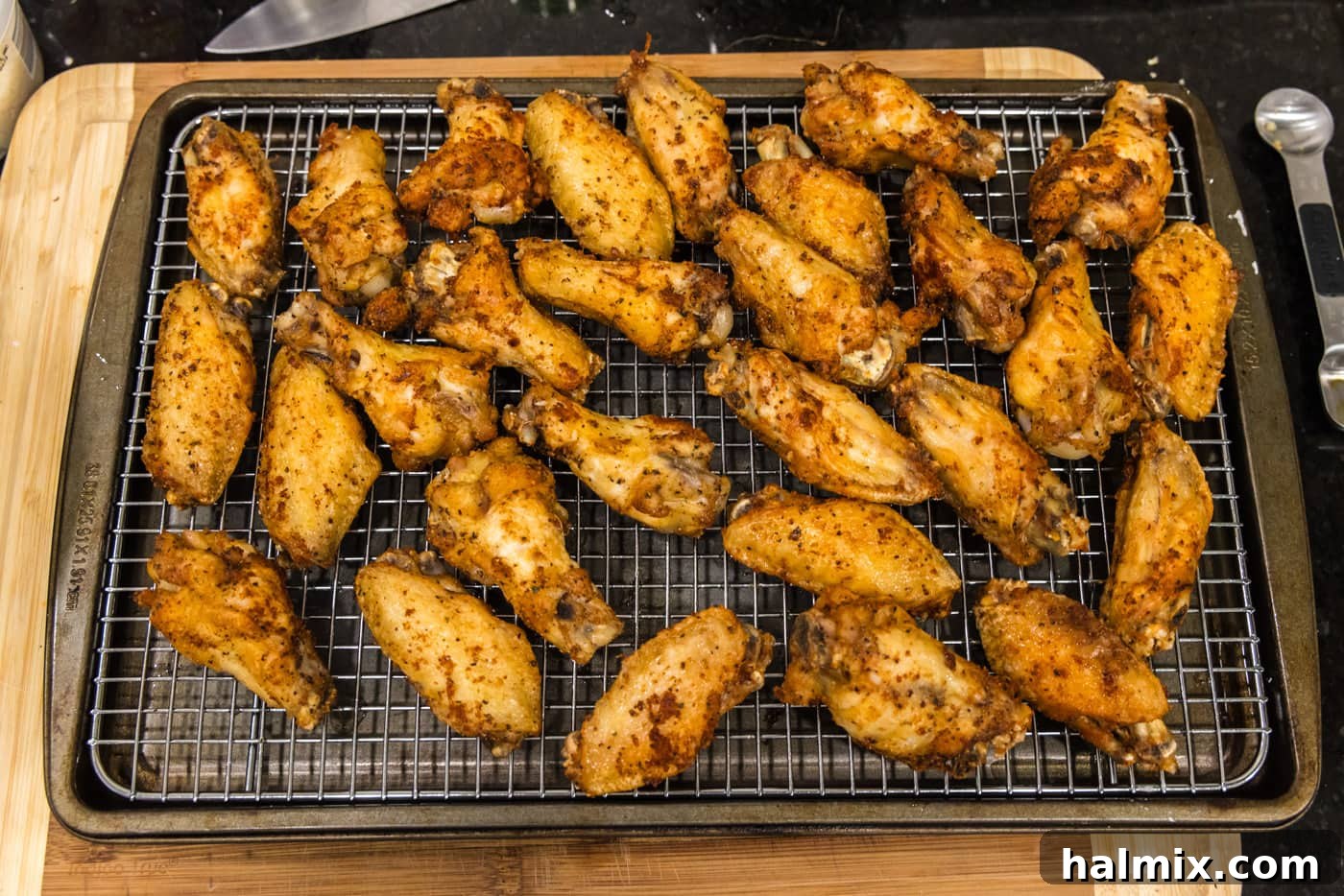 Crispy Garlic Parmesan Wings 14 crispy fried chicken wings on a cooling rack