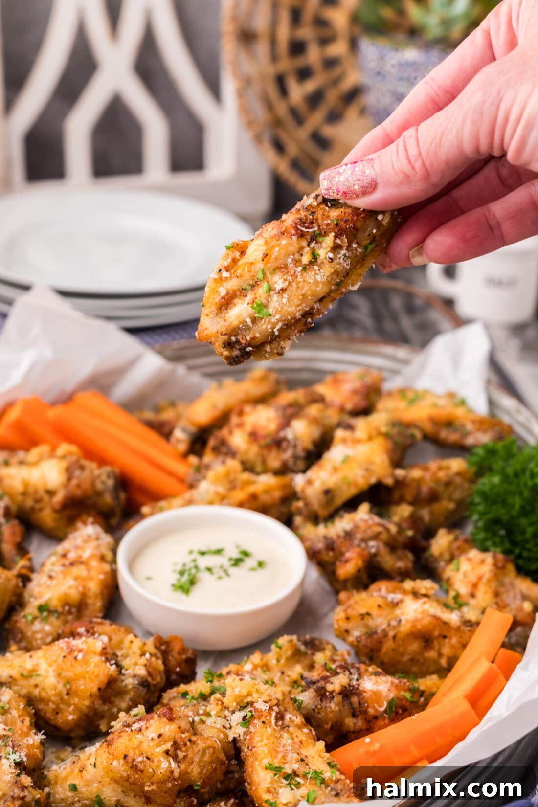 Crispy Garlic Parmesan Wings 17 Hand holding up a Garlic Parmesan Wing