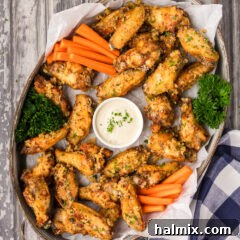 Crispy Garlic Parmesan Wings 18 Serving tray of Garlic Parmesan Wings with a bowl of dipping sauce in the center