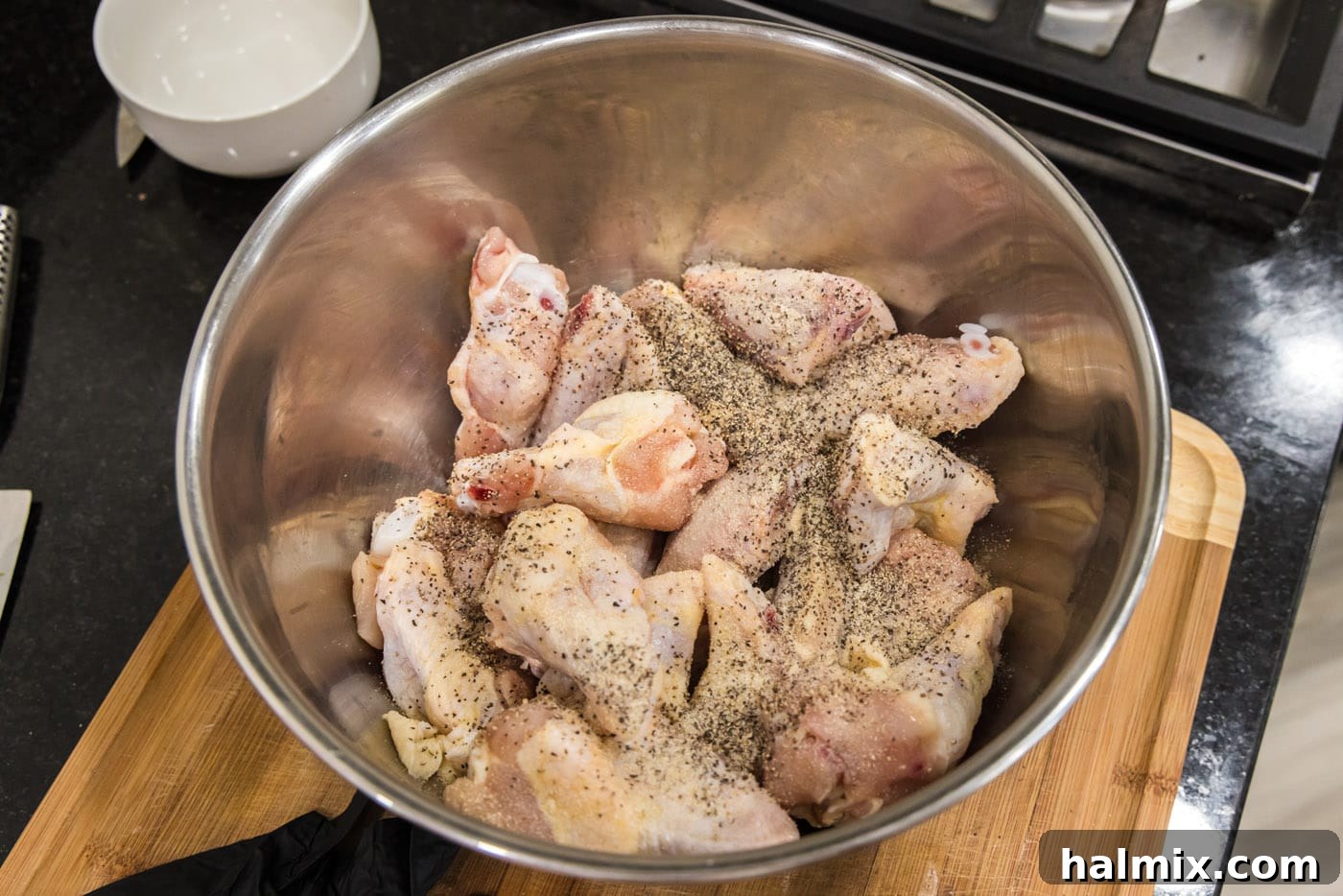 Crispy Garlic Parmesan Wings 5 chicken wings with garlic salt and pepper in a bowl