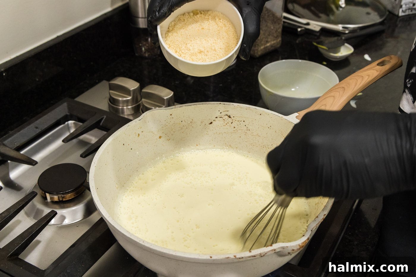 Creamy Chicken and Shrimp Carbonara 13 Adding grated Parmesan cheese to the heavy cream and egg mixture in the skillet, to be whisked into the carbonara sauce.