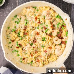 Close up photo of a skillet of Chicken and Shrimp Carbonara