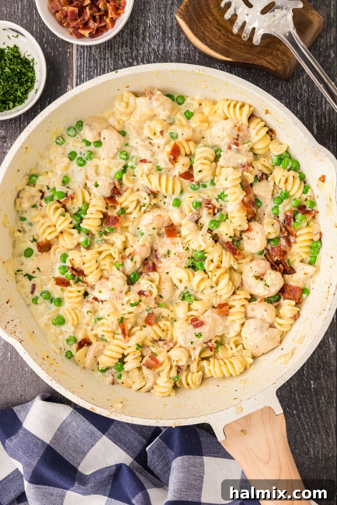 Creamy Chicken and Shrimp Carbonara 3 Skillet filled with creamy Chicken and Shrimp Carbonara, ready to be served, garnished with fresh herbs.