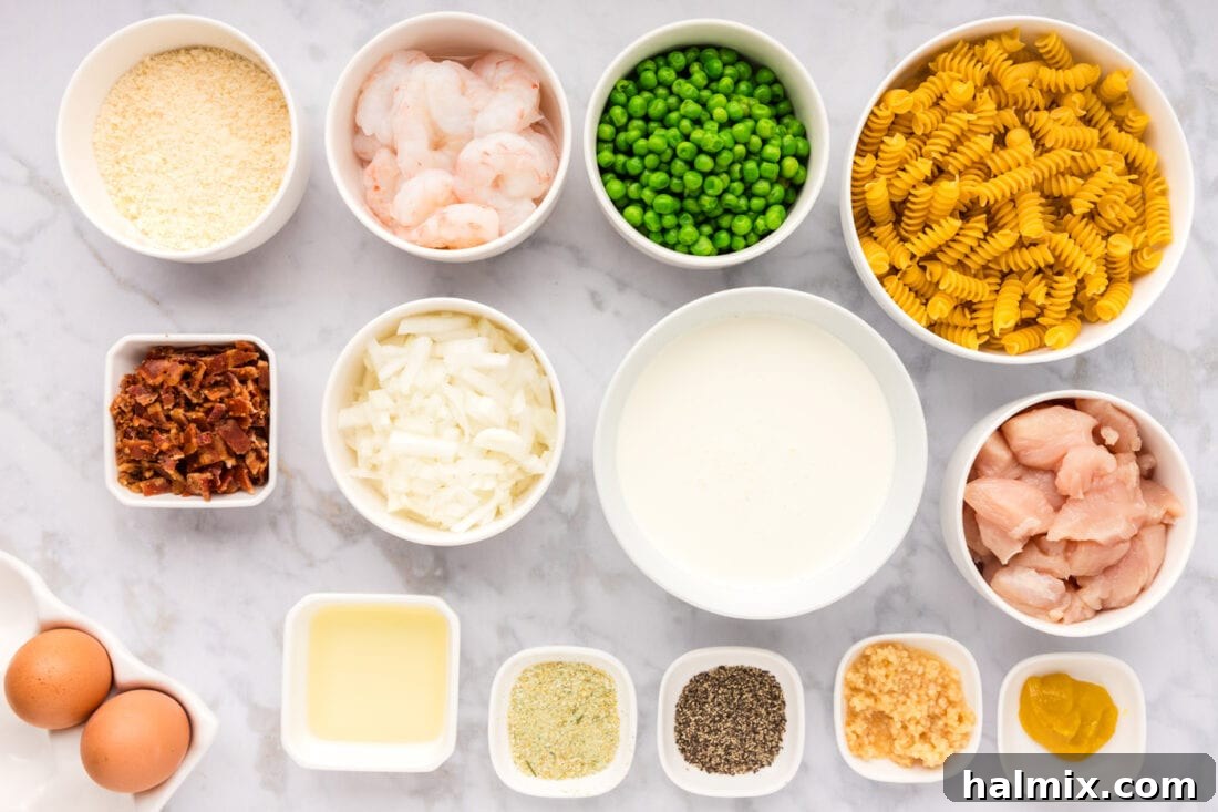 Creamy Chicken and Shrimp Carbonara 4 A flat lay photograph displaying all the fresh ingredients meticulously arranged for preparing Chicken and Shrimp Carbonara, including pasta, chicken, shrimp, garlic, cream, cheese, and peas.