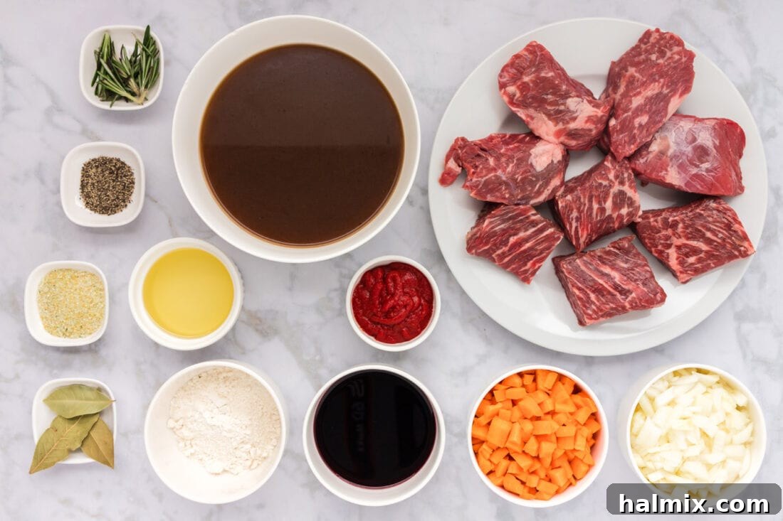 Fall-Off-The-Bone Short Ribs 4 A selection of fresh ingredients laid out, including beef short ribs, carrots, onions, red wine, and herbs, ready for braising.