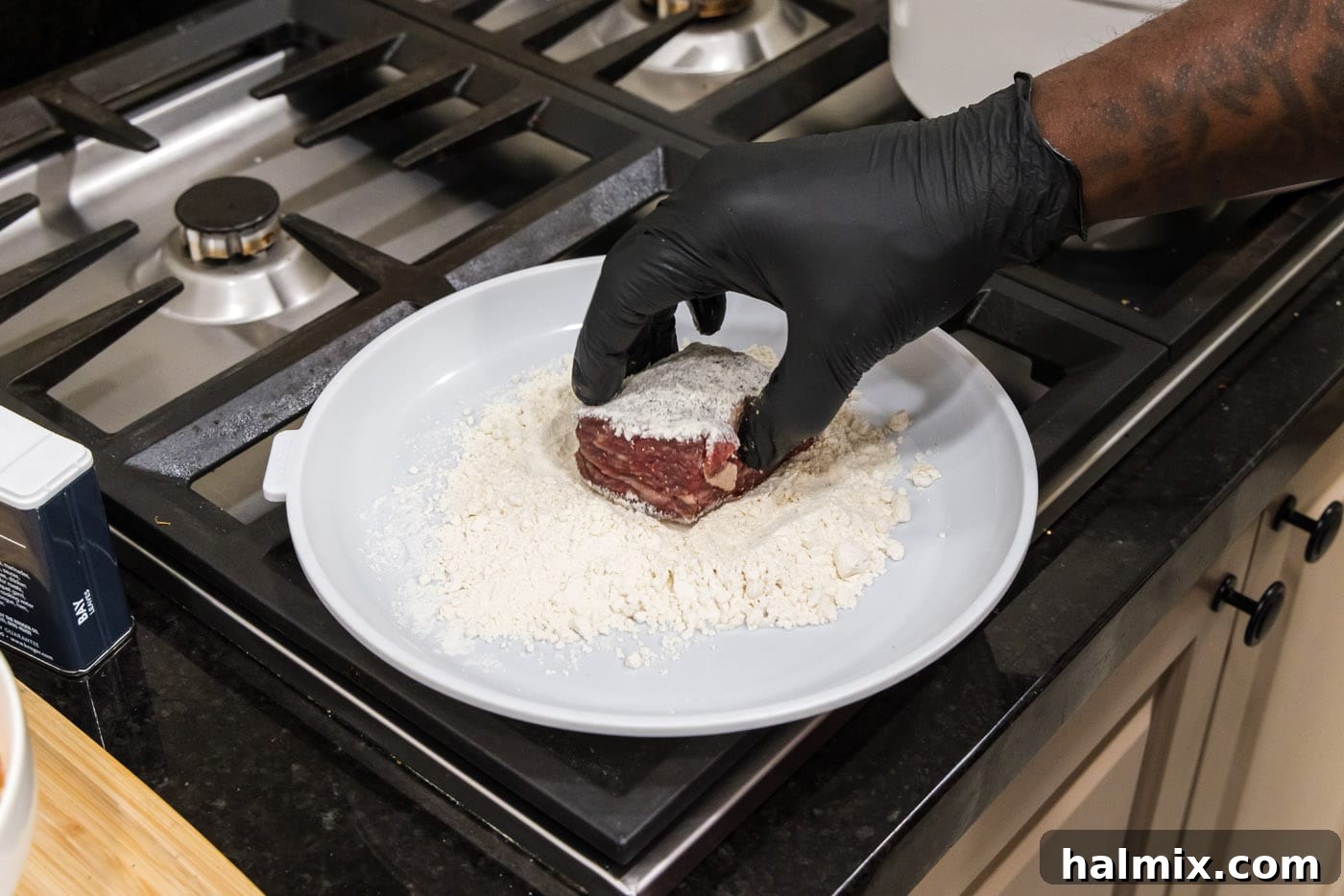 Fall-Off-The-Bone Short Ribs 8 Dredging beef short ribs in flour, ensuring an even coating on all surfaces.