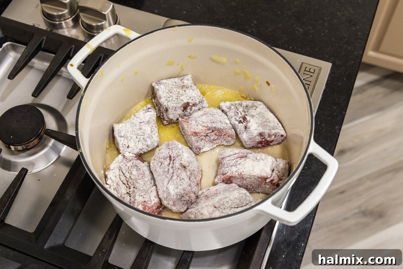 Fall-Off-The-Bone Short Ribs 9 Flour-dredged beef short ribs searing in a Dutch oven, developing a rich crust.