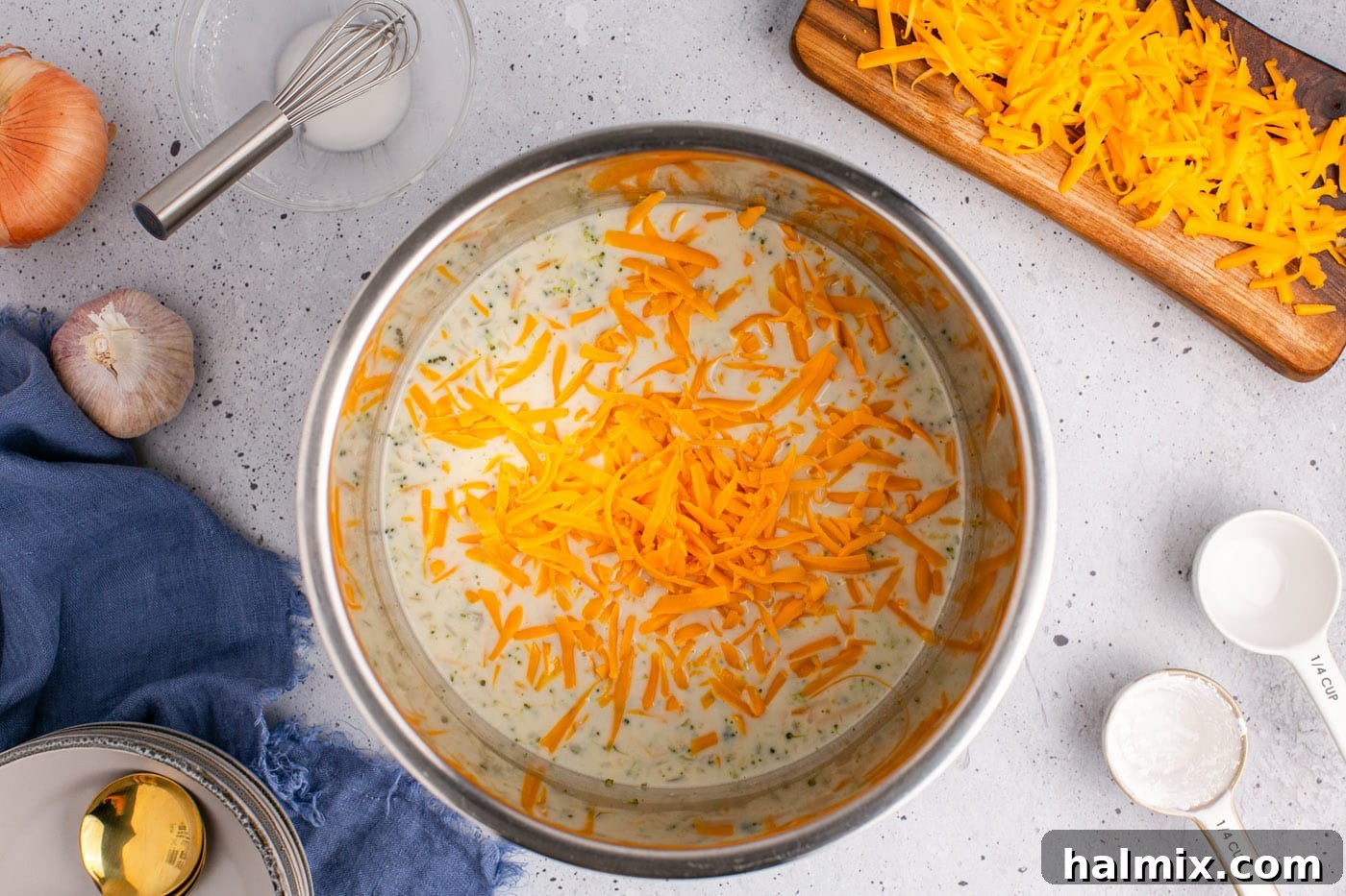 Golden Instant Pot Broccoli Cheddar Soup 11 Grated cheddar cheese and half and half being added to creamy broccoli cheddar soup in an Instant Pot