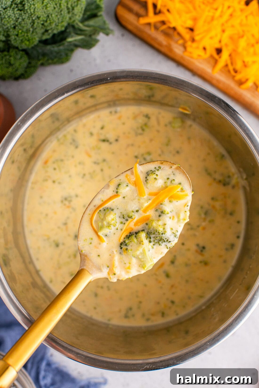 Golden Instant Pot Broccoli Cheddar Soup 13 Spoonful of Instant Pot Broccoli Cheddar Soup being lifted above the Instant Pot, showing its rich consistency