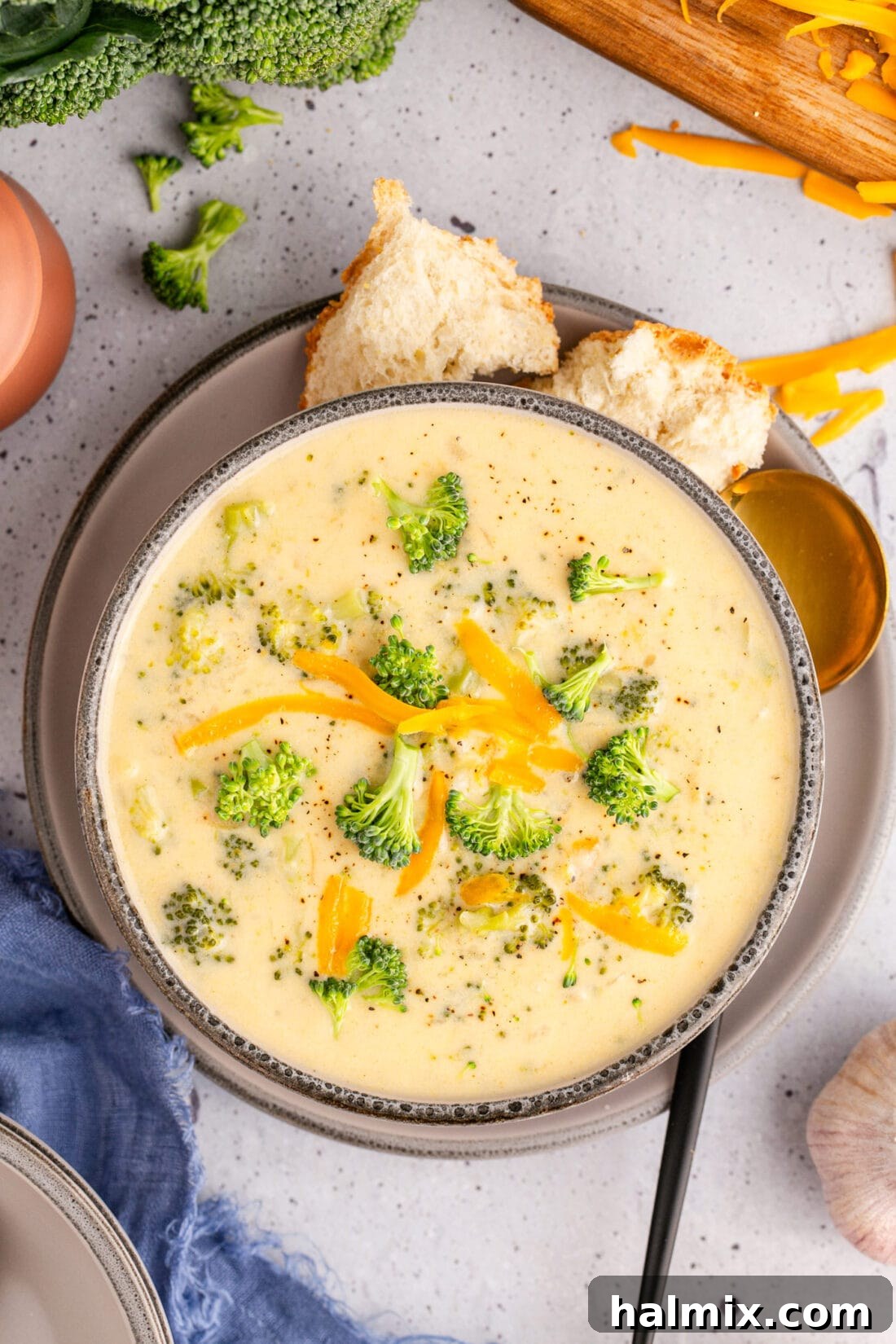 Golden Instant Pot Broccoli Cheddar Soup 3 Overhead photo of a bowl of Instant Pot Broccoli Cheddar Soup with crusty bread on the side, ready to serve