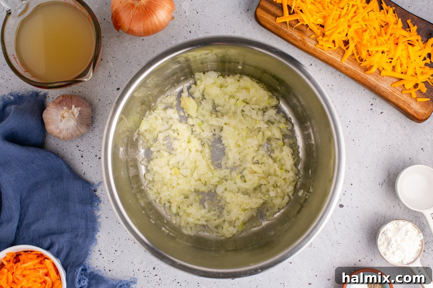 Golden Instant Pot Broccoli Cheddar Soup 6 Diced onions sautéing in melted butter in an Instant Pot