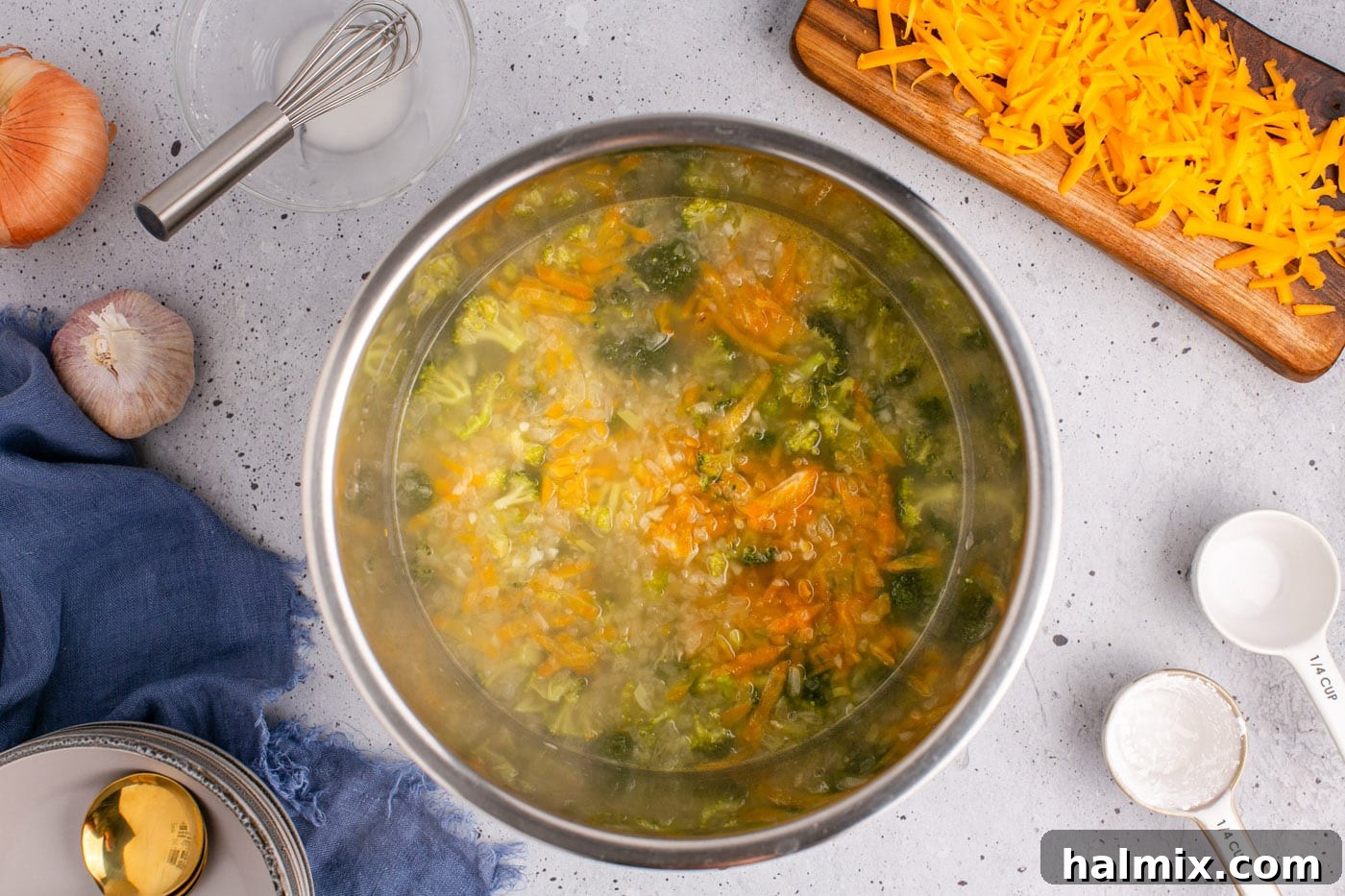 Golden Instant Pot Broccoli Cheddar Soup 9 Chicken stock being poured into the Instant Pot with vegetables and seasonings