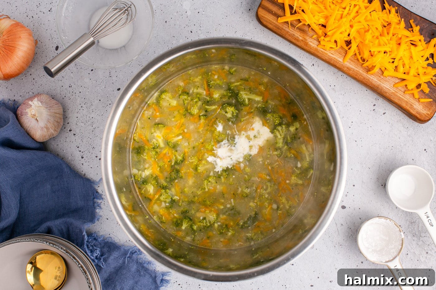 Golden Instant Pot Broccoli Cheddar Soup 10 Cornstarch slurry being slowly added to the Instant Pot broccoli cheddar soup to thicken