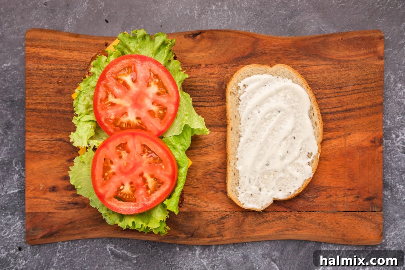 Fried Chicken Ranch Melt 9 Tomato and lettuce being added as the final fresh layers to the chicken bacon ranch sandwich
