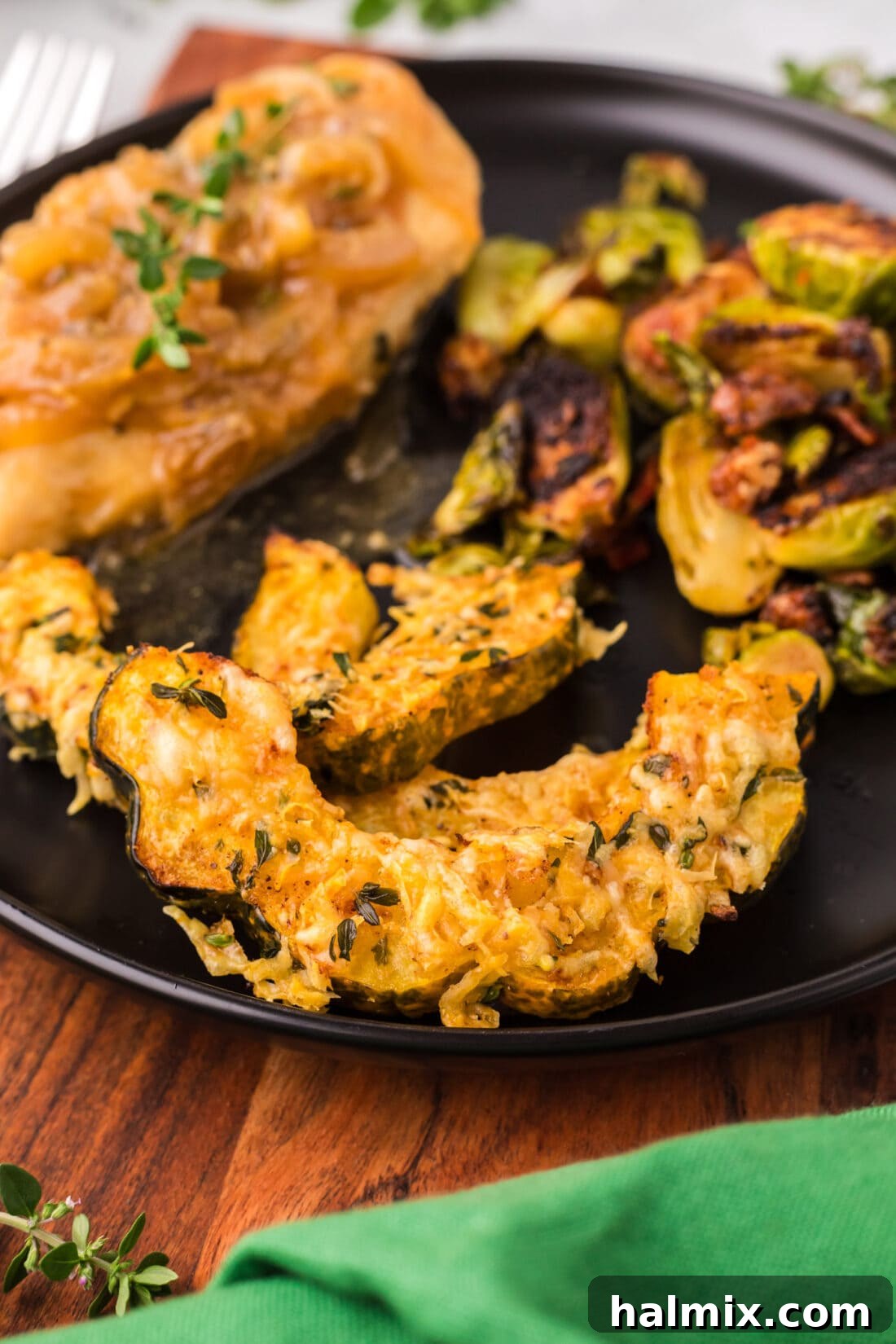 Plated Air Fryer Acorn Squash with Brussels sprouts and chicken, forming a balanced and delicious meal.