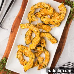 Air Fryer Acorn Squash on a white serving platter, beautifully roasted and garnished.