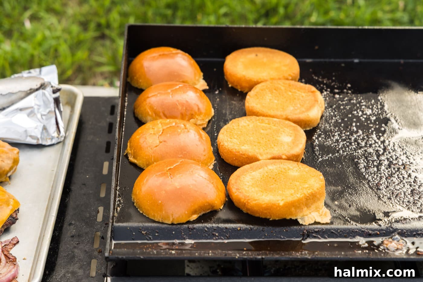 toasting burger buns on a grill, achieving a perfect golden crisp.
