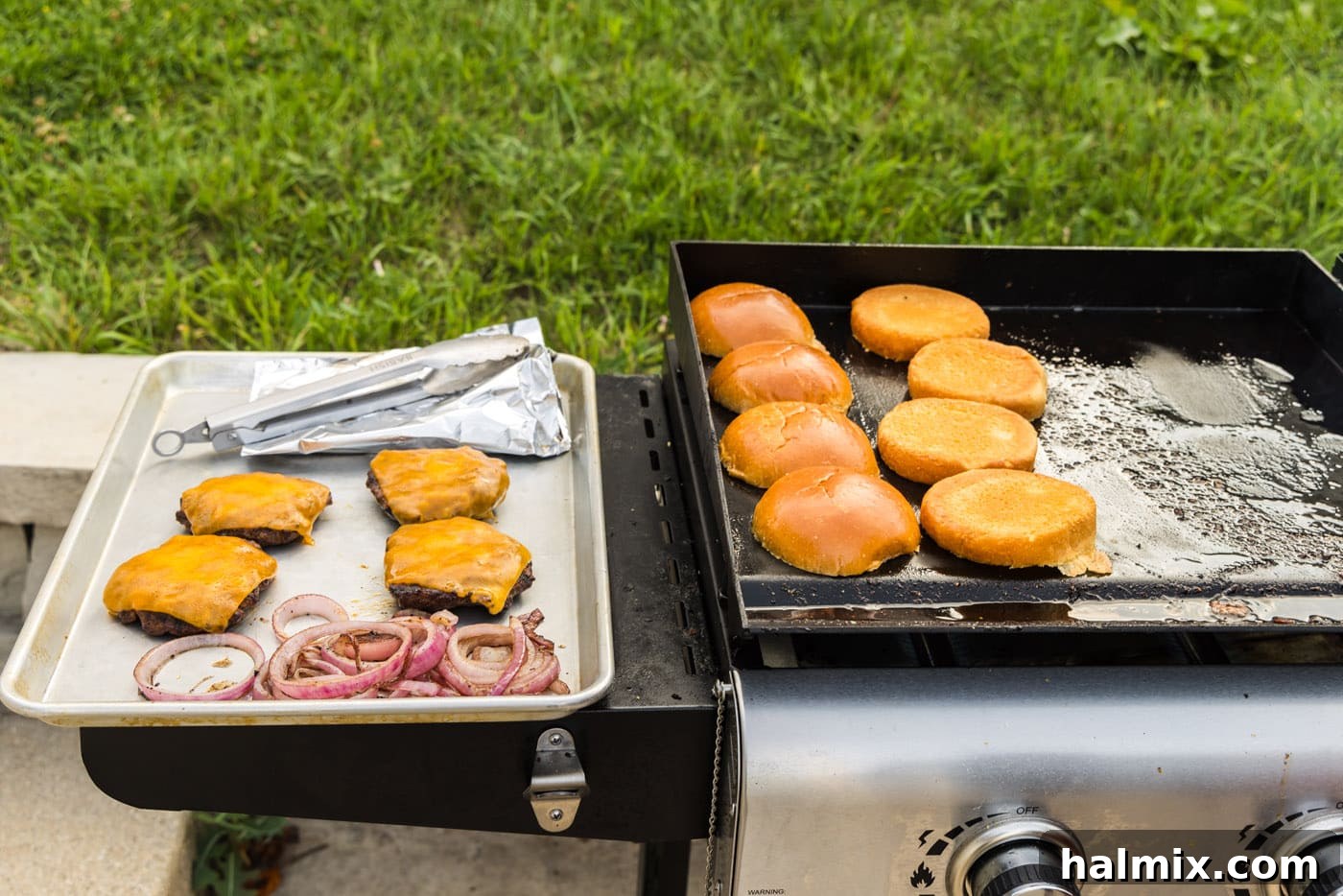 buns, burger patties, and grilled onions on the grill, a mouth-watering display of perfectly cooked components.