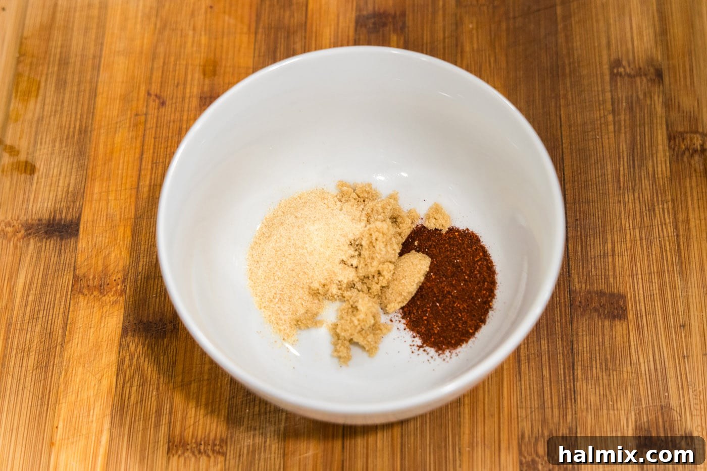burger seasonings in a bowl, showing a blend of garlic powder, brown sugar, and chili powder.