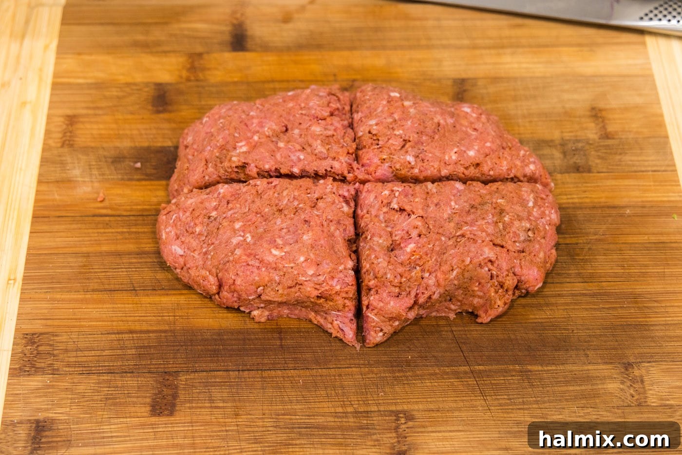 slicing burger patty into 4 triangles, illustrating portioning the meat.