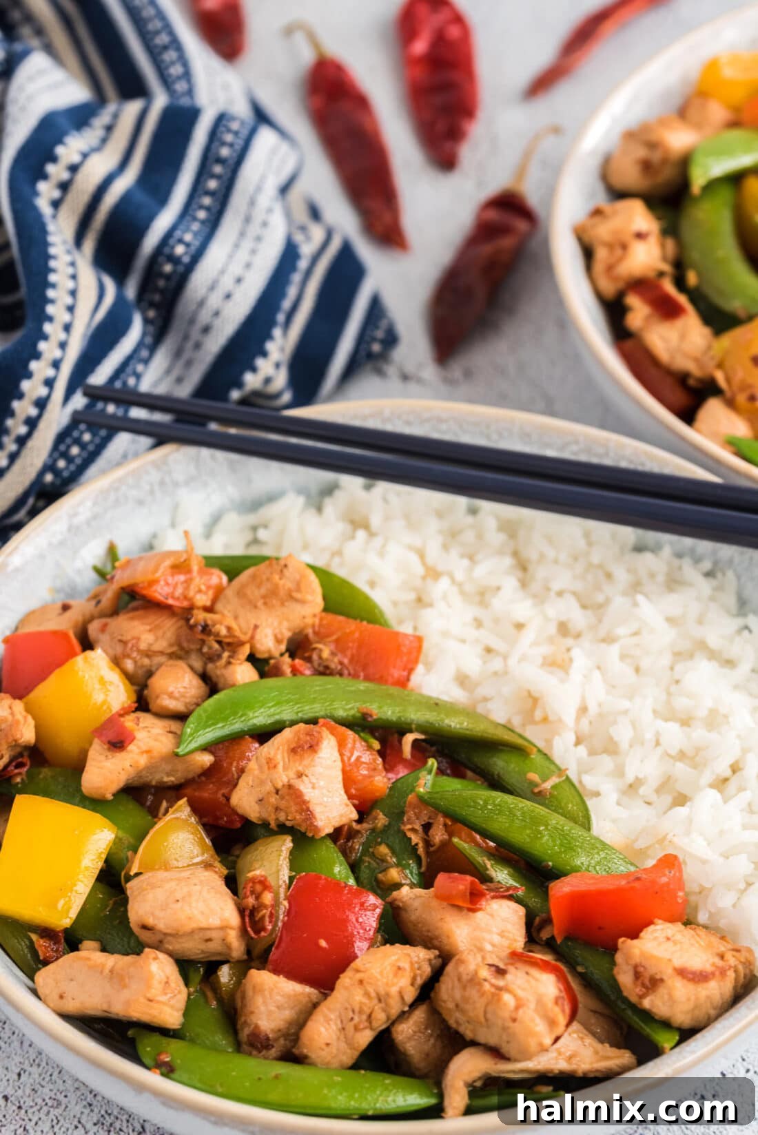 Delicious Homemade Kung Pao Chicken served with rice, garnished with fresh herbs.