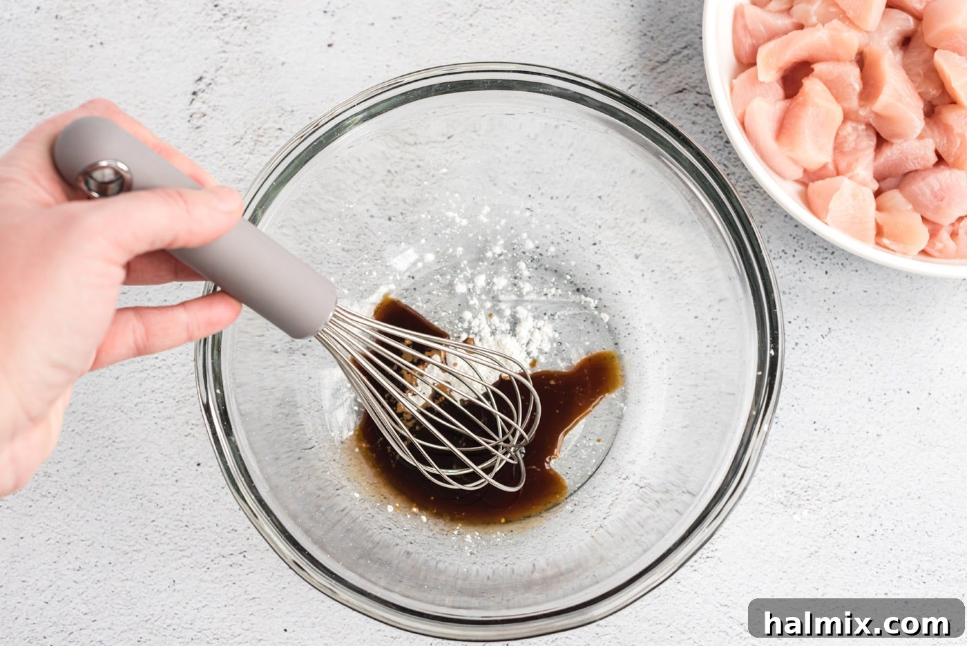 Cornstarch and soy sauce being mixed in a bowl.