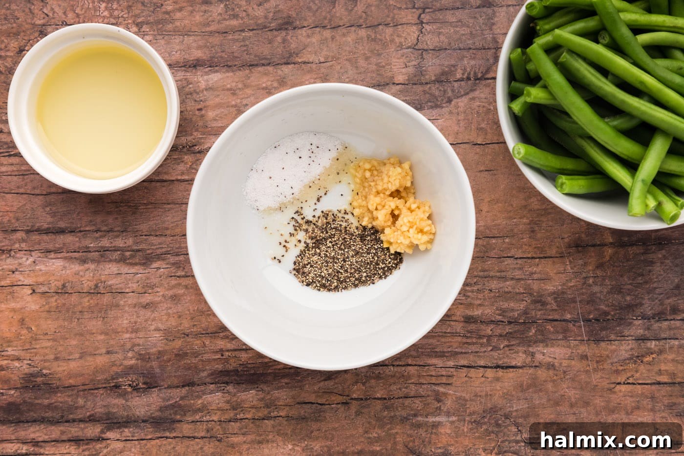 Salt, pepper, and minced garlic in a bowl, ready to be mixed with olive oil.