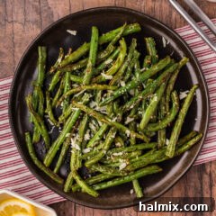 Air Fryer Green Beans artfully arranged on a black plate, showcasing their inviting texture and delicious appeal.