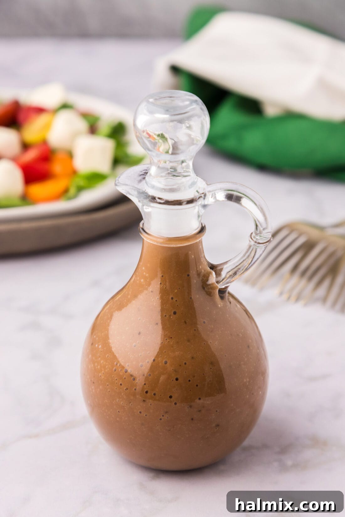 Sweet-Tart Balsamic Dressing 2 Homemade Balsamic Vinaigrette in a glass cruet, ready to be served
