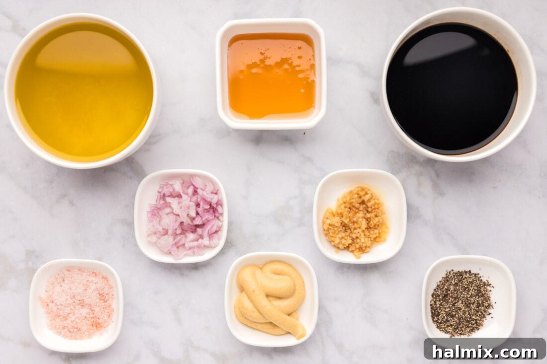 Sweet-Tart Balsamic Dressing 4 A flat lay of fresh ingredients required for Balsamic Vinaigrette, including vinegar, oil, honey, garlic, and shallots.