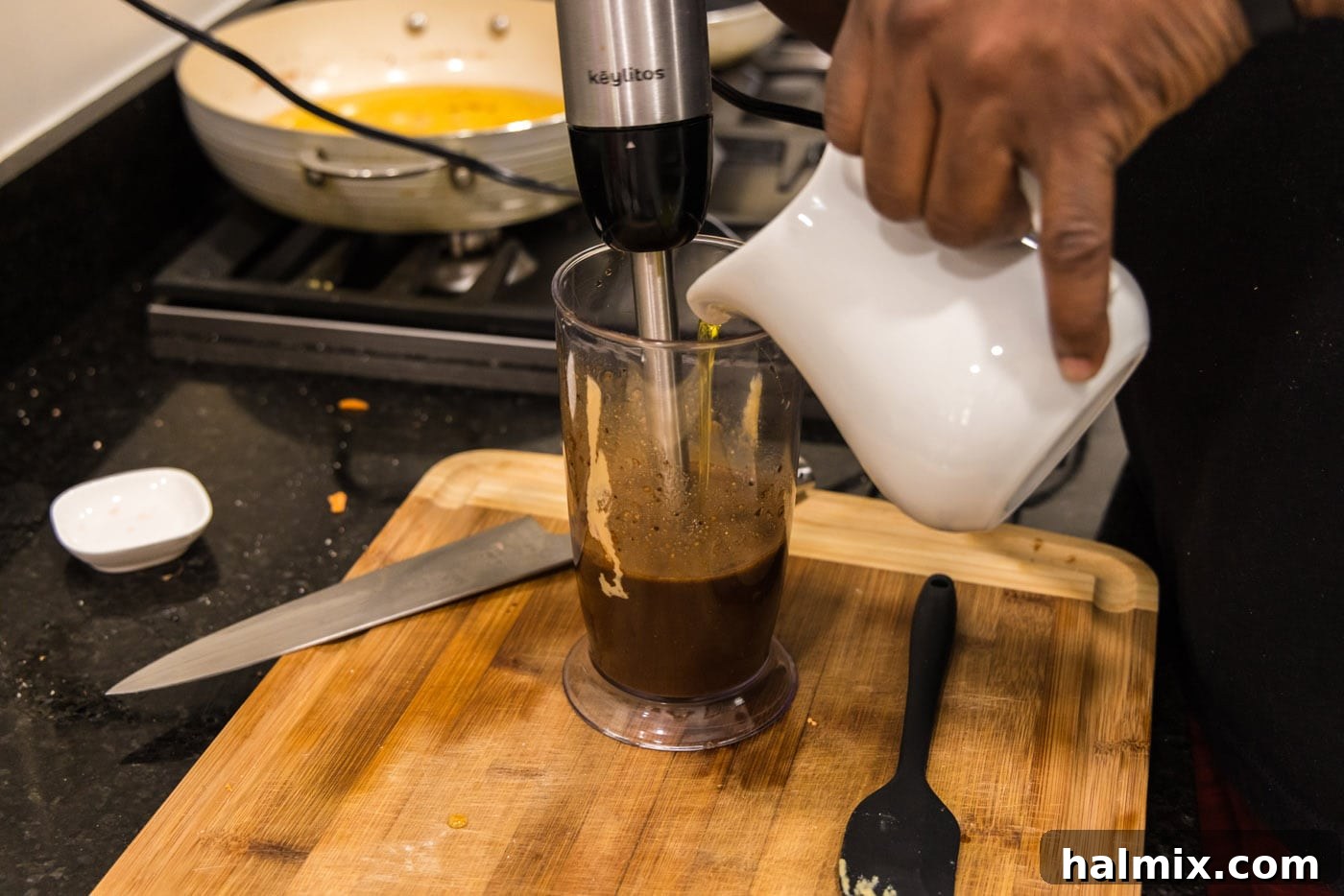 Sweet-Tart Balsamic Dressing 7 Pouring olive oil into balsamic dressing while blitzing with an immersion blender to emulsify