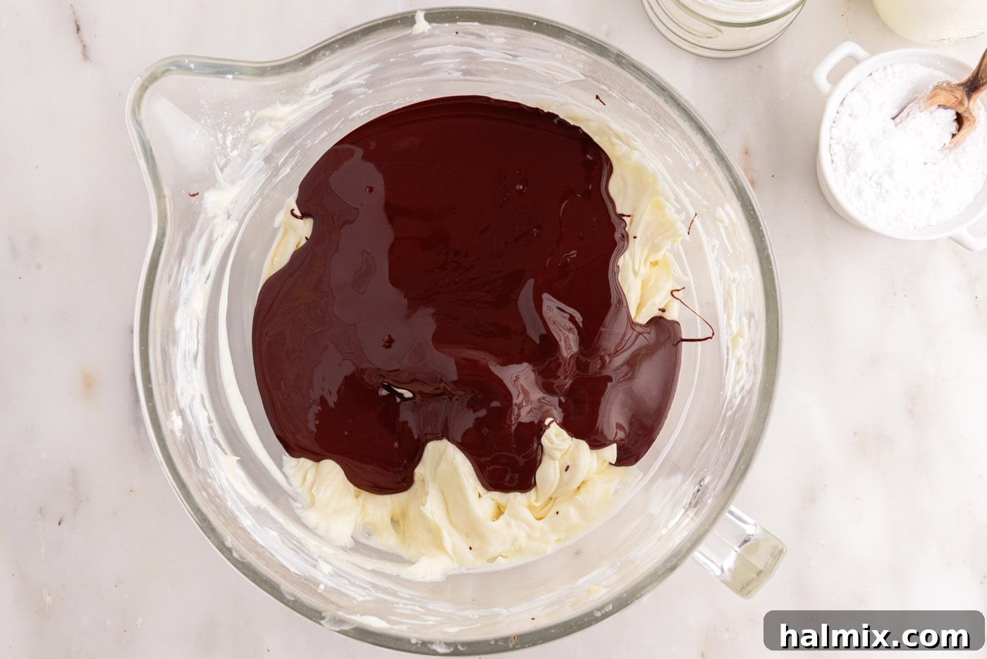 melted chocolate added to cheesecake mixture in a bowl