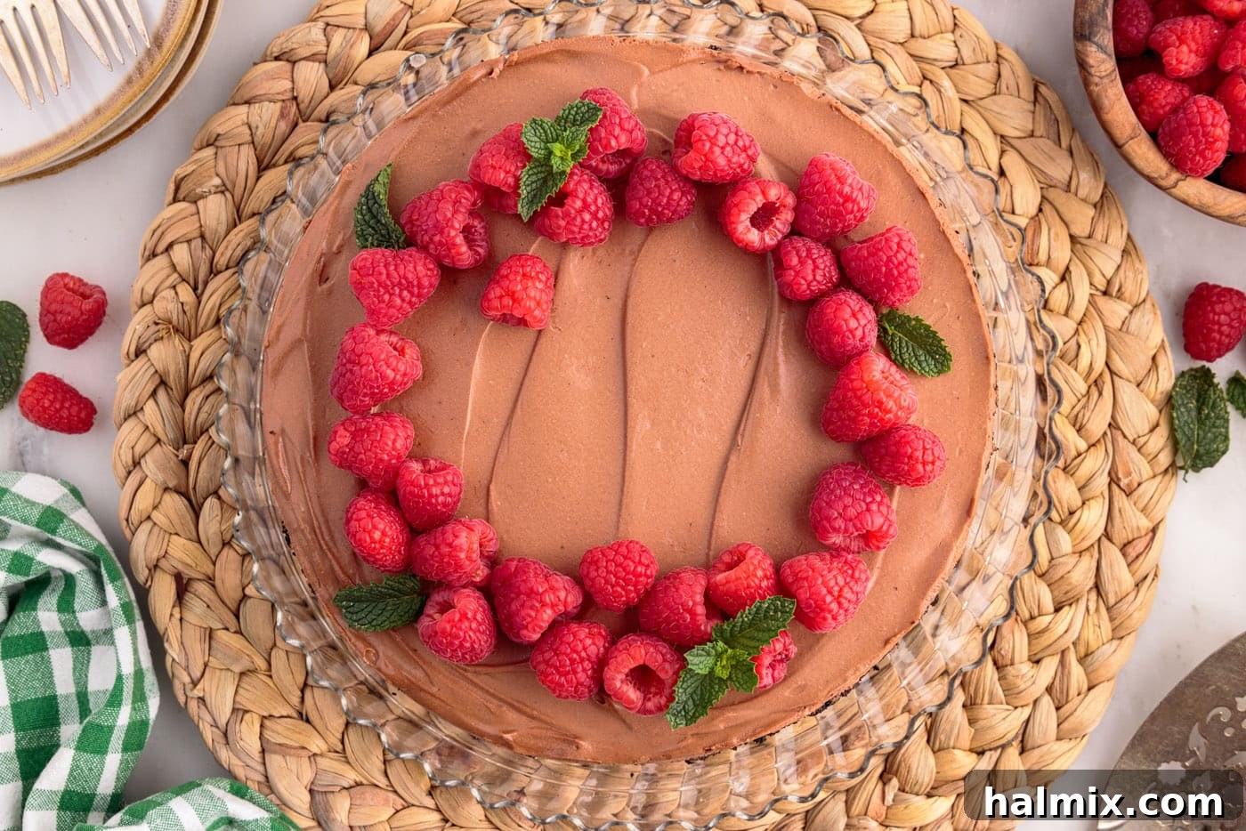 fresh raspberries and mint on top of no bake chocolate cheesecake