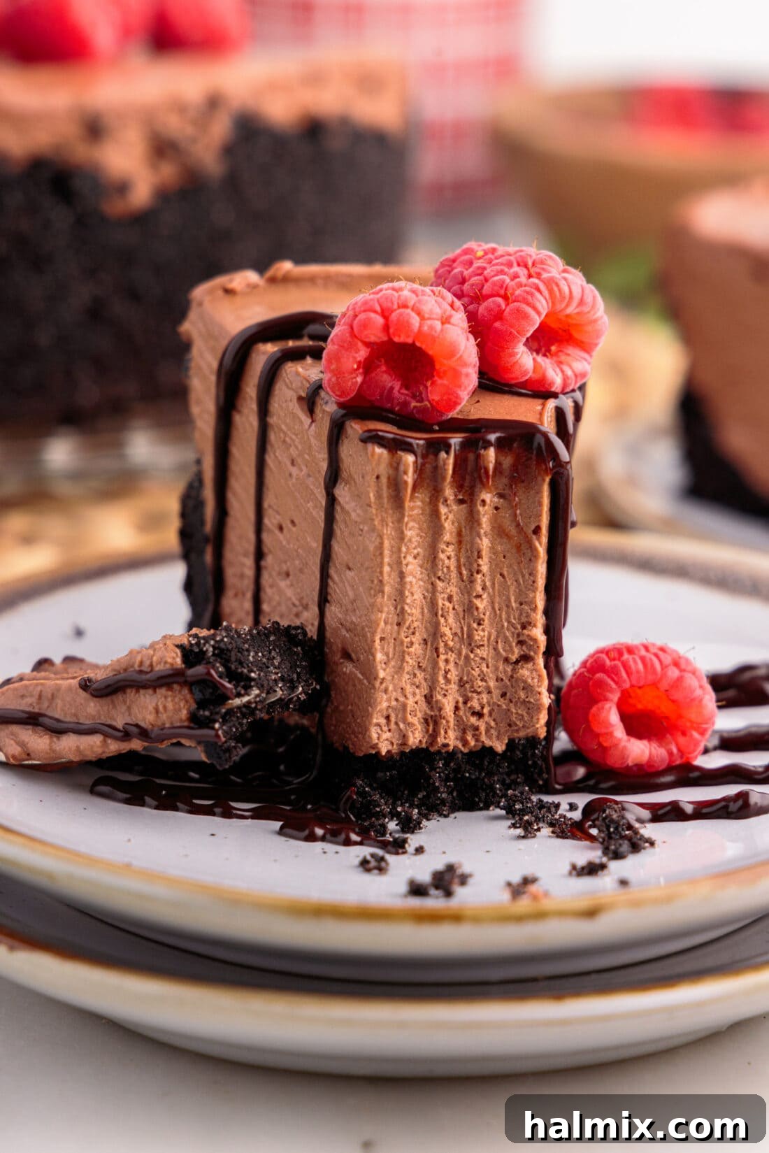Slice of No Bake Chocolate Cheesecake on a plate with a bite taken out using a fork