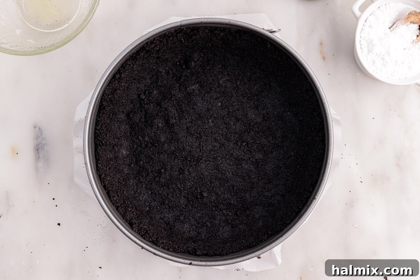 chocolate graham cracker crust for cheesecake in a springform pan