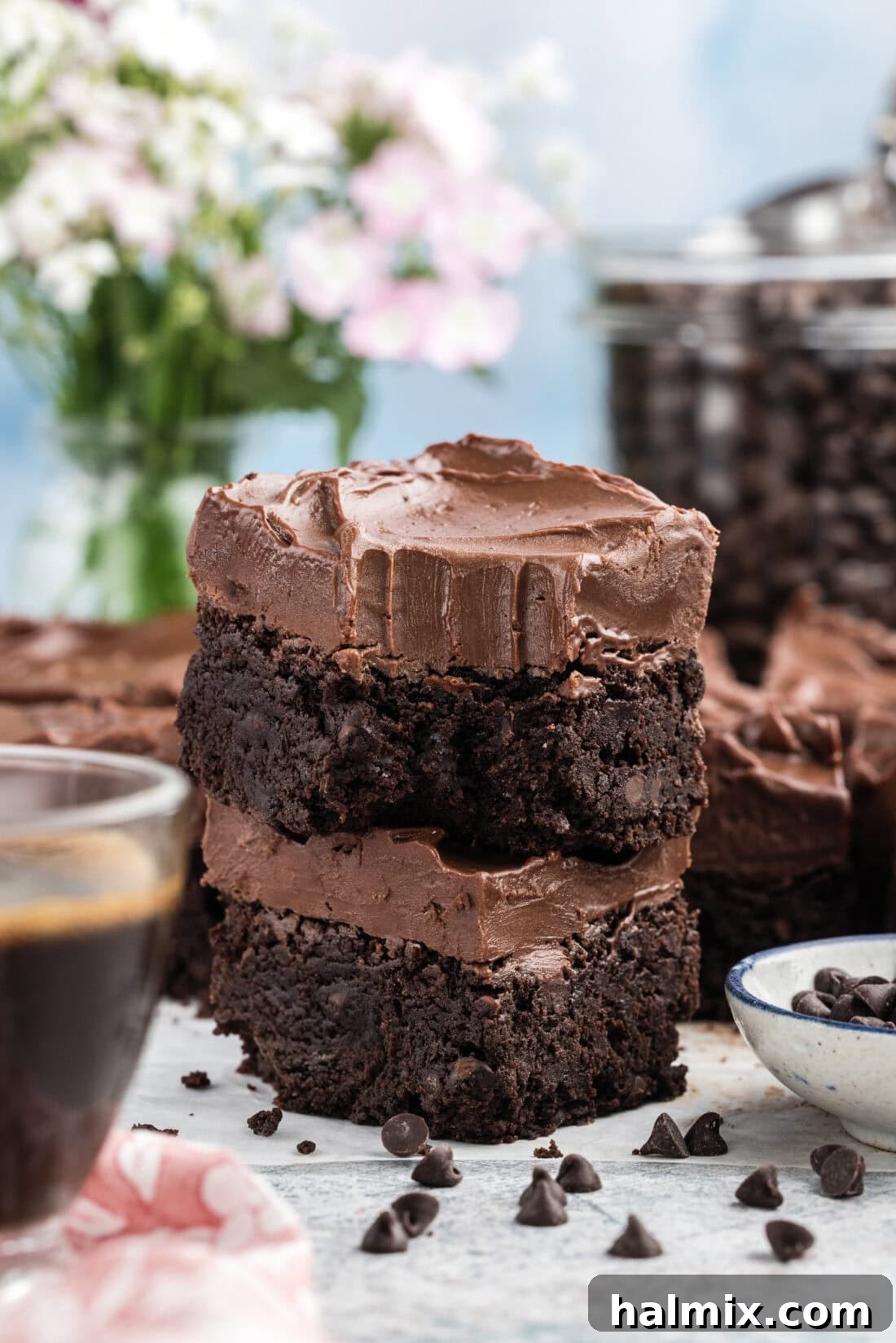 Stack of Fudge Frosted Espresso Brownies with a delicious bite taken out of the top one