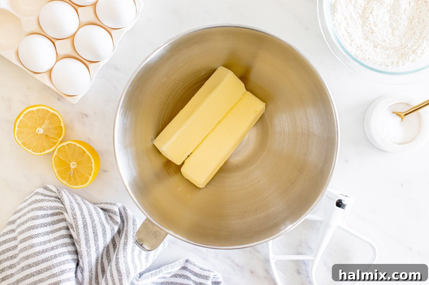 Two sticks of room temperature butter in a stand mixer bowl, ready to be creamed.