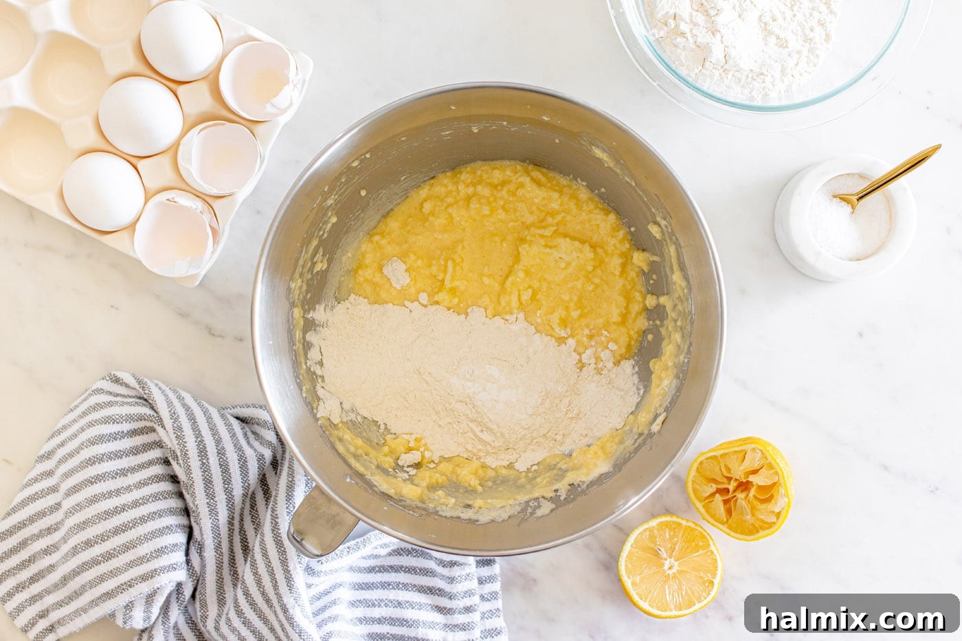 Gently incorporating dry ingredients into the wet batter for the lemon pound cake.