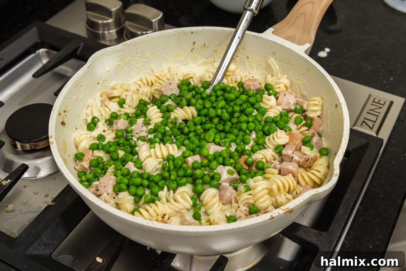 Vibrant frozen peas added to the rich Turkey Carbonara in the skillet, adding color and a hint of sweetness.