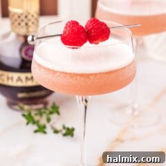 Close up photo of a French Martini garnished with raspberries