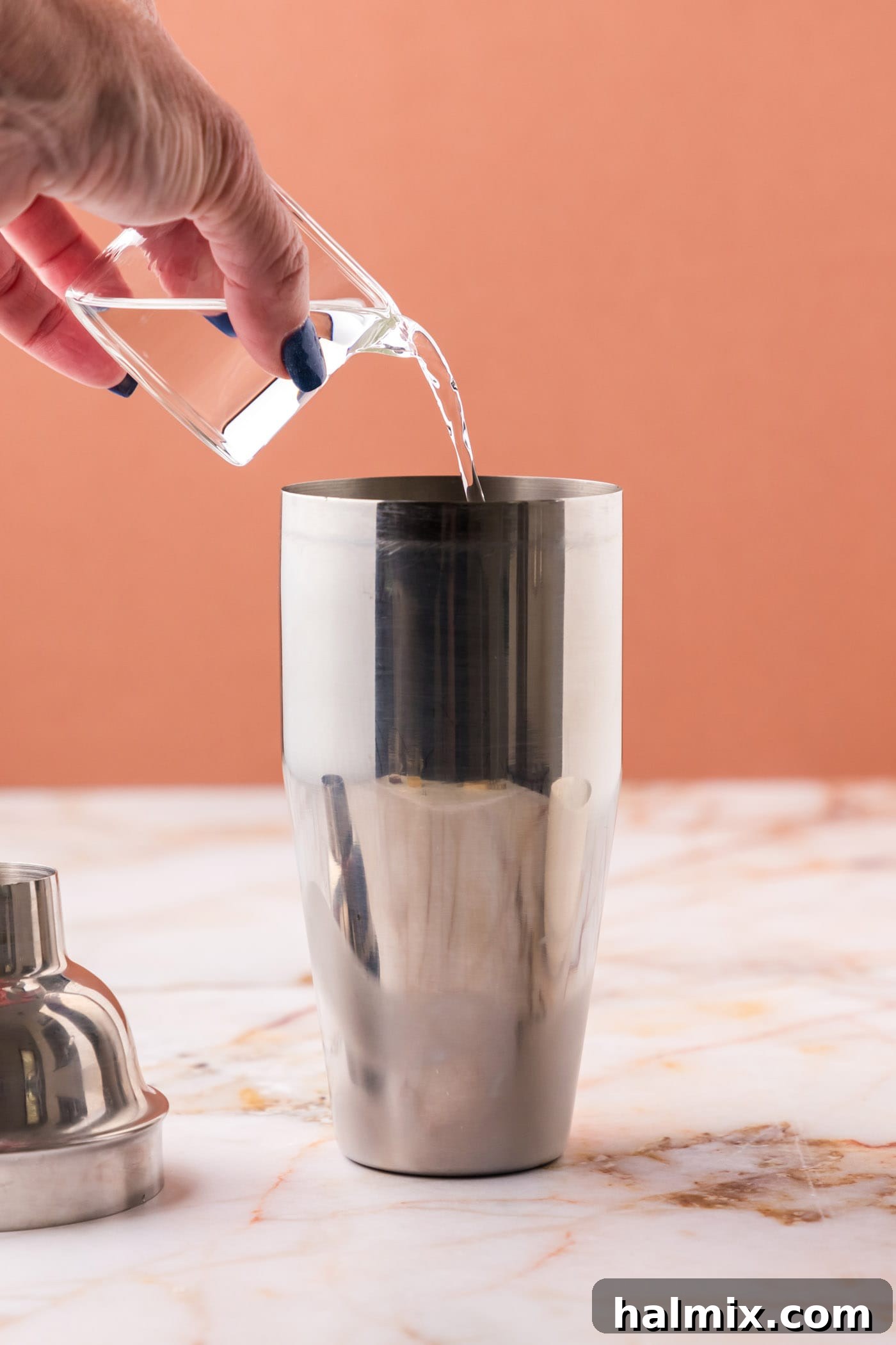 pouring vodka into cocktail shaker
