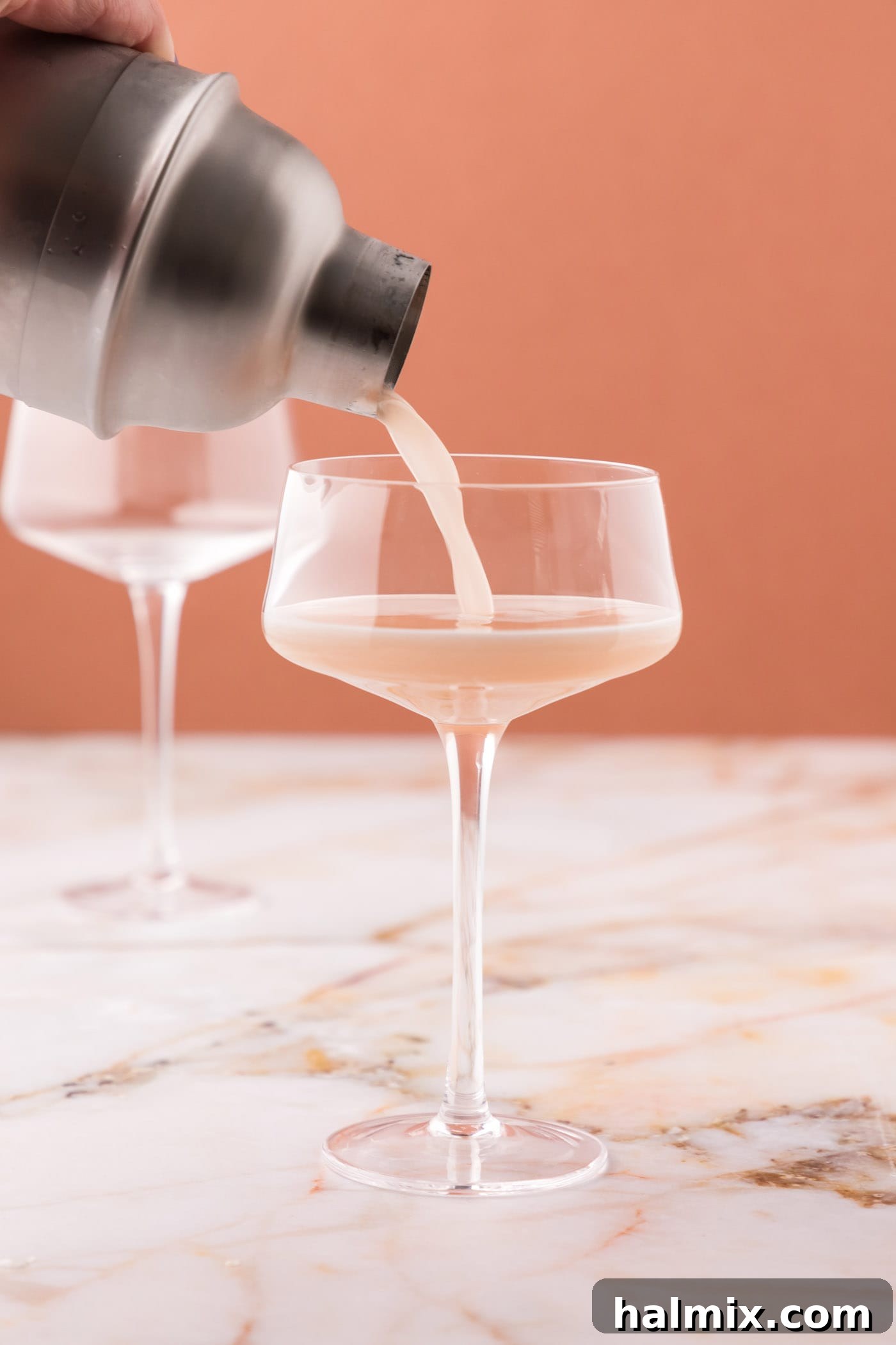 straining french martini into a glass