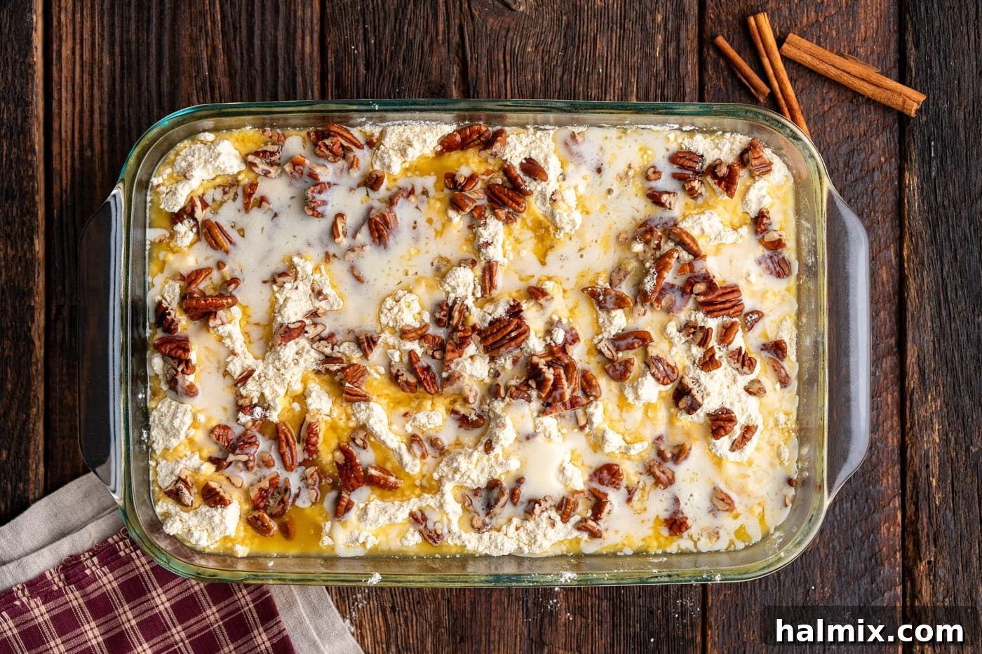 melted butter drizzled over dump cake with pecans
